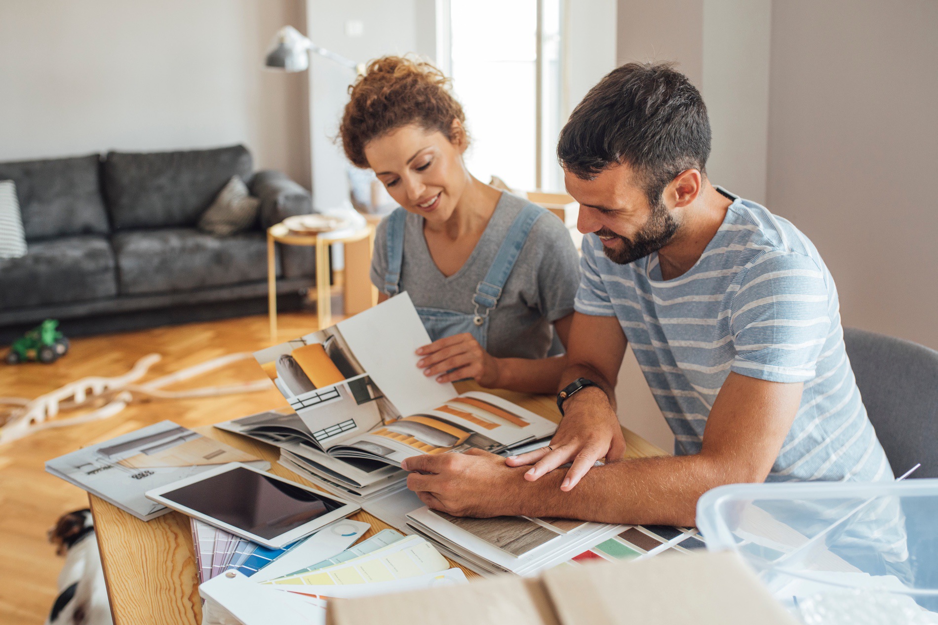 A couple sitting at a table reviewing choices of construction renovations.