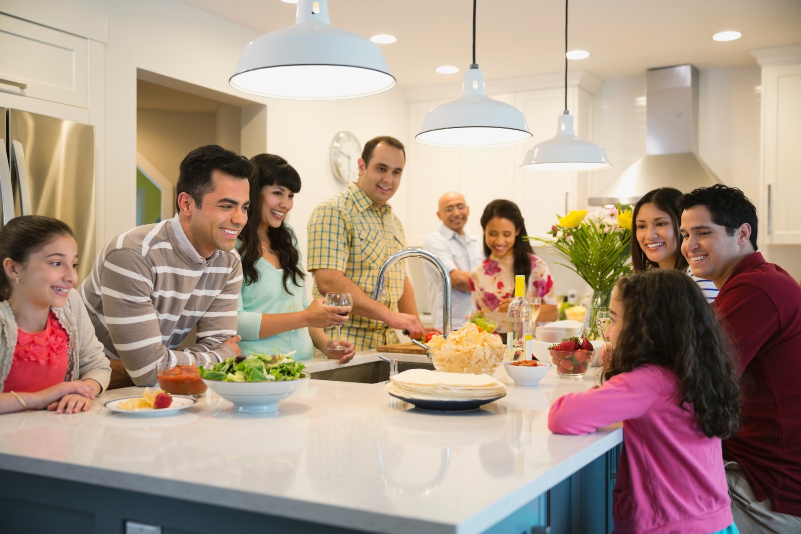 photo of a family gathered around kithen island